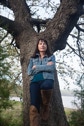Jeanetta Calhoun Mish leaning on the tree where she wrote her first poem